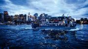 Boat cruising on Boston harbor at twilight 