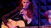 A photograph of Zoe Sarnak performing on stage