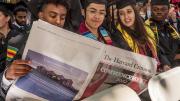 Graduates-to-be read the student newspaper, absent a University Gazette