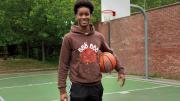 Ibrahim Barry with a basketball on a court