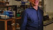David Reich standing in his Harvard Medical School laboratory