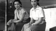 Two women seated looking into the film camera, from Japanese film Tokyo Story