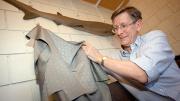 Bigelow professor of ichthyology George Lauder in his lab with a model of a shark (above) and a sample of the "sharkskin" swimsuit fabric that he studied. Some Olympic swimmers favor the high-tech fabric, believing that it increases speed.