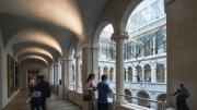 A few visitors in the arcade overlooking the Calderwood Courtyard of the Harvard Art Museums