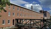 an exterior view of the mill and one of the canals constructed to divert river water to power its machinery