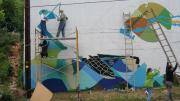 Community volunteers painting <i>Native Waters</i> in Atlanta, Georgia.