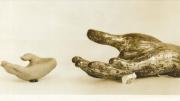 Photograph (c. 1935) of a fragment from a 12th–14th century Thai bodhisattva statue, along with the plasticene copy made by a pupil at the Perkins Institute who manually explored, and then copied, the hand.