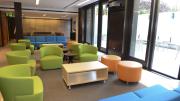 Colorful furniture in the basement-level common room next to the terrace. A student committee was consulted on furniture choices.