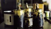 A can of black ink (on the left) and brass cans of type wash 