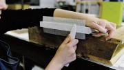Sarah Songer applies crash (coarsely woven cloth) to strengthen a book&rsquo;s sewn spine