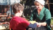 Traditional artisans, such as spinners, demonstrate their skills at Strawbery Banke.