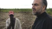 Father Christopher Hartley with a Haitian plantation worker