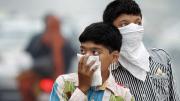Children protecting themselves from smog and pollution, New Delhi, 2012