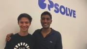 Upsolve co-founder Rohan Pavuluri (right) and summer staffer Nick Brown in front of an Upsolve sign.