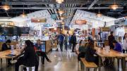 An indoor photo of people eating and shopping at Boston Public Market