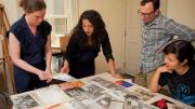 Hinton arranges materials for the Angela Davis exhibit with (from left) Radcliffe arts program manager Meg Rotzel, gallery coordinator Joe Zane, and Pforzheimer fellow Jackie Wang.