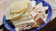 A blue plate displays half a dozen different dairy products that are staple foods of people living on the Eastern Steppe.