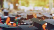 Photograph of students in caps and gowns graduating from college