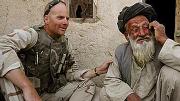 Photograph of Kit Parker on duty in Afghanistan, spring 2003, with a village leader in Kandahar Province
