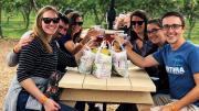 A group of people gather at one of Lookout's picnic tables after picking their own fruit 