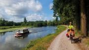Michael Lyon and son ride a bike next to a river.