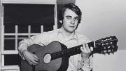 Photograph of William Randall playing guitar in his Lowell House room, c. 1970-1971