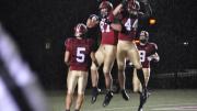 Levitation on a rainy night: Harvard receivers celebrated after a 35-yard touchdown pass to tight end Cameron Brate (87) in the opening period of the Crimson’s 52-3 rout of Holy Cross. Quarterback Colton Chapple threw two scoring passes to Brate and one each to Ricky Zorn (5) and Kyle Juszczyk (44) in a 49-point first half.