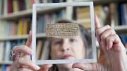 Hollis professor of divinity Karen L. King with the papyrus fragment on which is written the Gospel of Jesus's Wife.