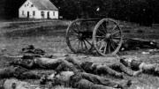 Dead Confederate artillerymen grouped near one of their limbers after Antietam. In the background is a Dunker church, built by a German Baptist pacifist sect.