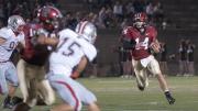Hard-running quarterback Conner Hempel (14) gives Harvard’s ground game an added dimension. Hempel ran the ball 11 times as Harvard overcame Brown, 41-23.