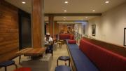 A student sitting in a basement common space.
