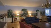 An elaborate mural, displaying an early American scene. 