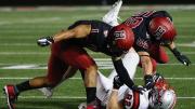 Tag team: Harvard senior captain and defensive back Wes Ogsbury Jr. (1) and senior linebacker Joey Goodman (59) doubled up on Brown end Dan Gemmell.