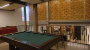 A multi-level common with a pool table in front