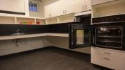 The Lowell House kitchen with an accessible oven on right.
