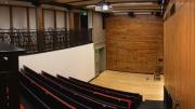 A tiered, downward-sloped theatre with 64 seats