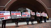 hotograph of demonstrators in front of the federal courthouse in Boston where the SFFA v. Harvard trial took place, with signs reading "Harvard No More Racial Stereotyping" and "My Race Should Not Hurt Me In Admissions.