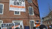 Divest Harvard signs hangs from Mass. Hall.
