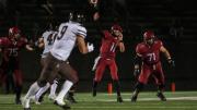 Charlie Dean throws a football across field.
