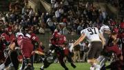 Sophomore back Sone Ntoh runs through a tackle