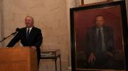 Lawrence H. Summers at the lectern next to his official portrait