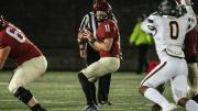 Photograph of quarterback Charlie Dean under pressure before finding his rhythm