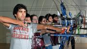 Samuel Saidel-Goley (foreground) and Archery Club colleagues draw their bows.
