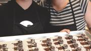 The sisters with their “Duchess of Earl” Earl Grey-flavored truffles.  After dipping, they push each one to the side to prevent a trailing  “foot” of excess dipped chocolate.