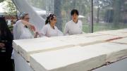 Chang and employees keep working to align the cakes precisely.