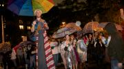 The Divinity School parade had a "pilgrimage" theme and was led by a colorful stilt walker.