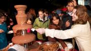 Party-goers enjoy one of two chocolate fountains. The food tents were popular as people crowded underneath to get out of the downpour.