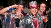 Students from the Harvard Business School (HBS) party on despite the rain. The HBS contingent in the parade carried replicas of the centennial bell from that school's 2008 anniversary.