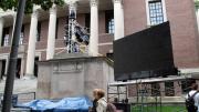 Tercentenary Theatre is being outfitted with four large LED projection screens, like this one flanking Widener Library, so guests can see the proceedings, a Harvard slide show, and—during the celebration—images of the 375th party and even, perhaps, themselves.