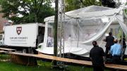 Workers assembled the cake under a tent to protect it from the rainy weather. A Harvard Dining Services truck brought over the individual sheet cakes, which form the 15-by-18-foot H-shaped cake. Sixty individual sheet cakes were baked, two per day, by Flour bakery and deep frozen at Harvard awaiting the day of the celebration.